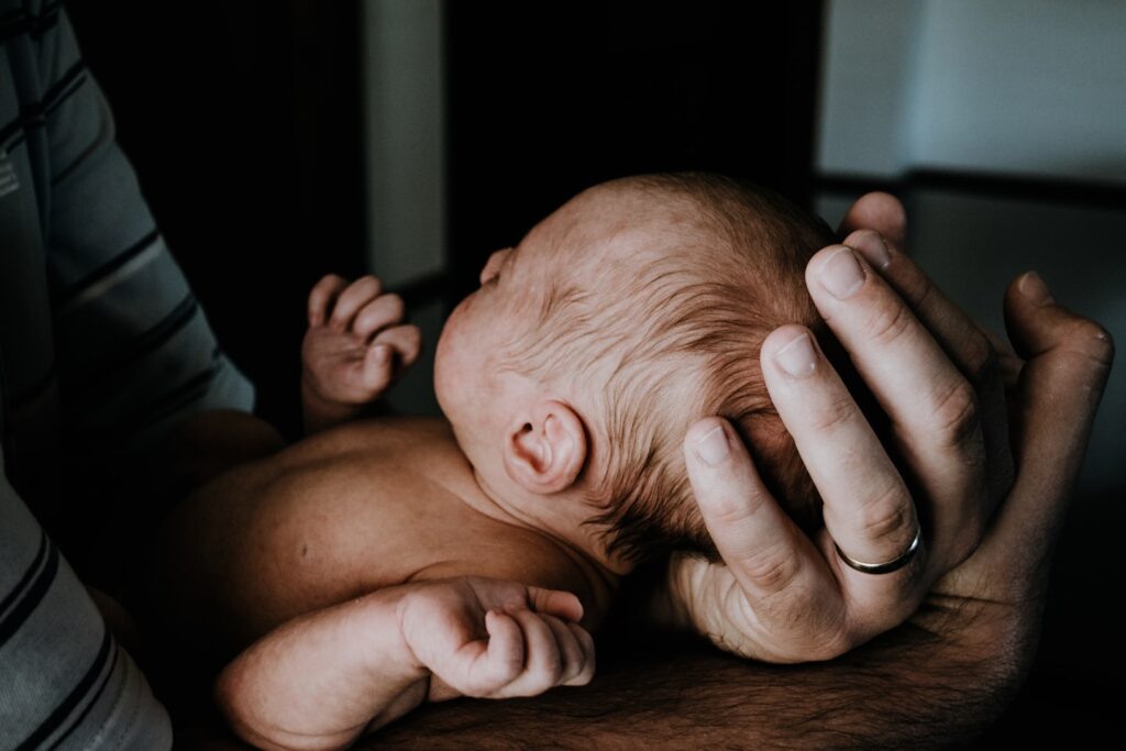a man holding a baby in his arms